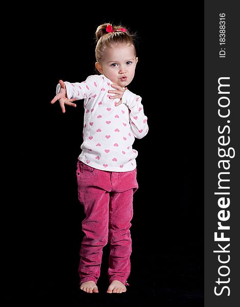 A cute kid with a funny facial expression and a cute pose!  She is wearing a heart T shirt. A cute kid with a funny facial expression and a cute pose!  She is wearing a heart T shirt.