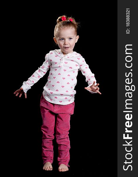 A cute kid with a funny facial expression and a cute pose!  She is wearing a heart T shirt. A cute kid with a funny facial expression and a cute pose!  She is wearing a heart T shirt.