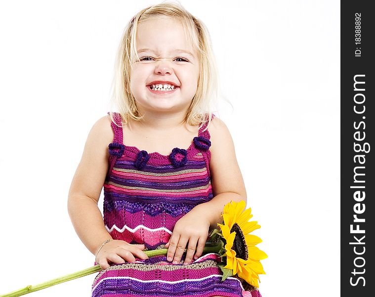 Young pretty blond girl happy and smiling with a sunflower. Young pretty blond girl happy and smiling with a sunflower