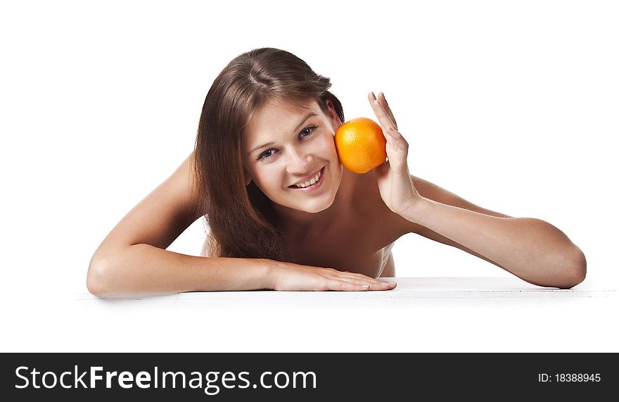 The adult woman with an orange fruit