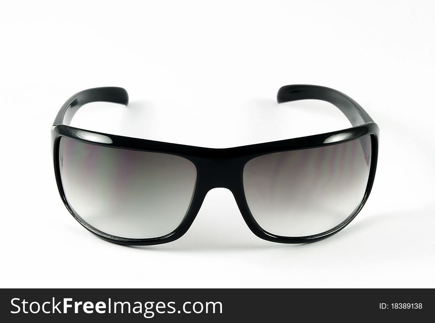 Modern sunglasses on white surface