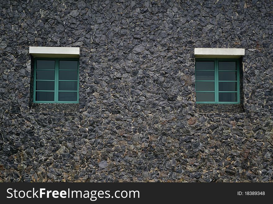 Shuttered green window on painted brick black wall. Shuttered green window on painted brick black wall