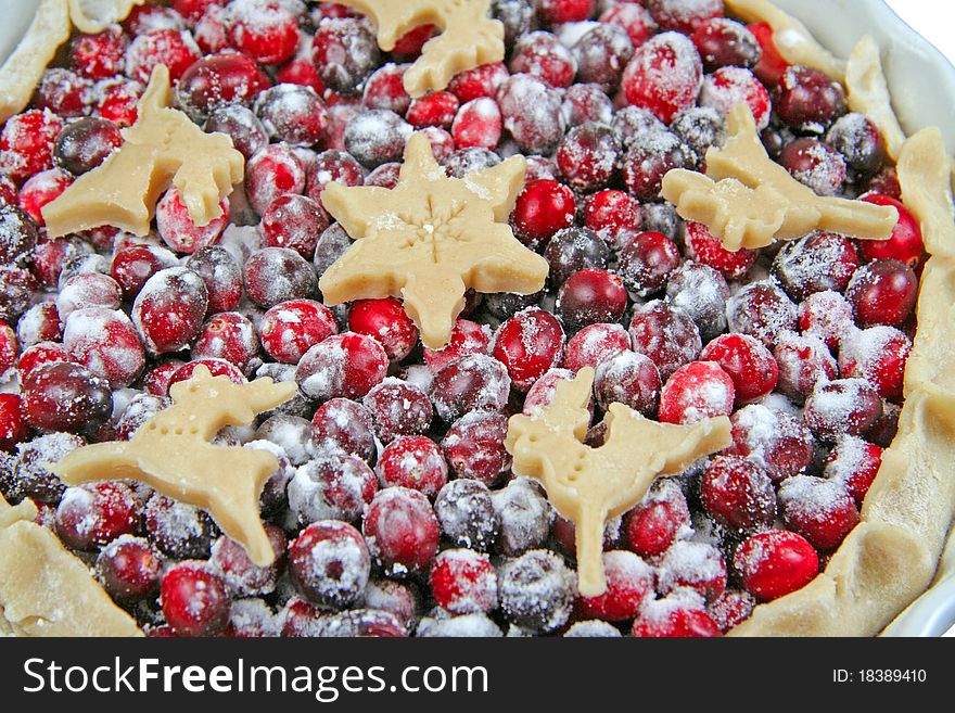 Closeup of raw cranberry tart with Christmas decorations. Isolated. Closeup of raw cranberry tart with Christmas decorations. Isolated.