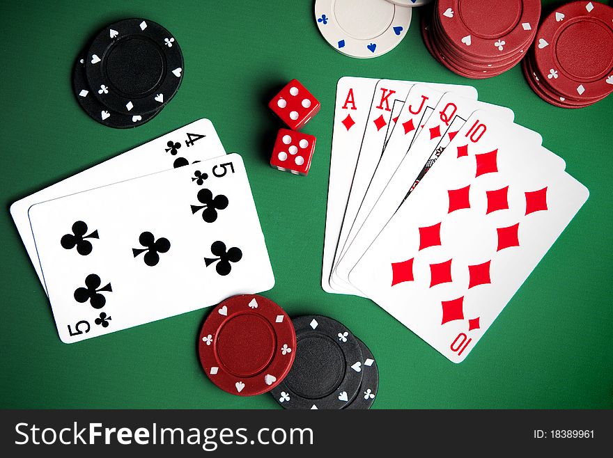 Playing cards and chips on a green background