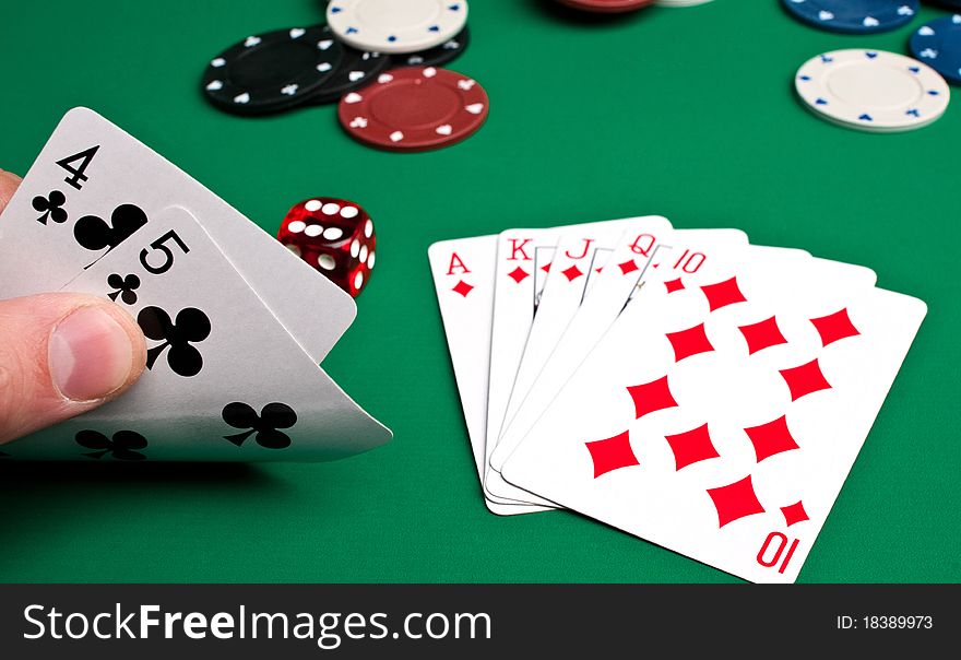 Playing cards and chips on a green background