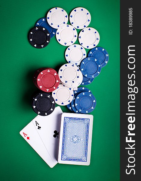 Playing cards and chips on a green background