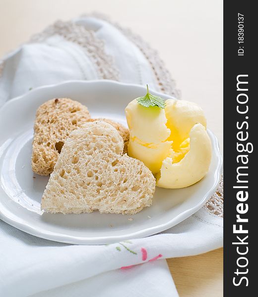 Heart shaped bread with cereals with butter