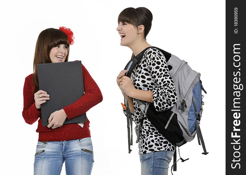 Two friends with a backpack and a book posing. Two friends with a backpack and a book posing