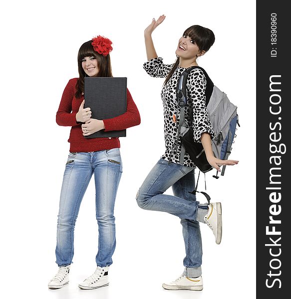 Two friends with a backpack and a book posing. Two friends with a backpack and a book posing