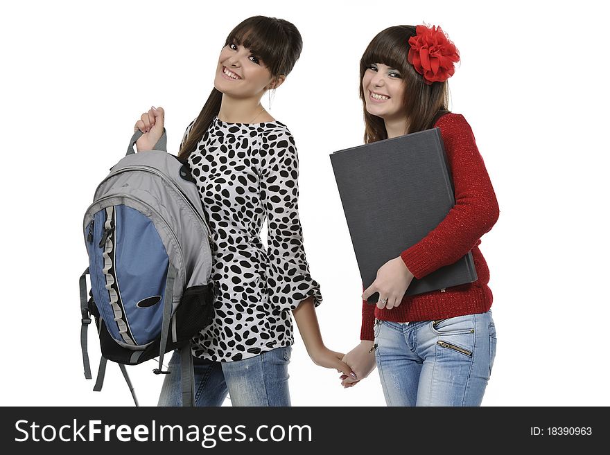 Two friends with a backpack and a book posing. Two friends with a backpack and a book posing