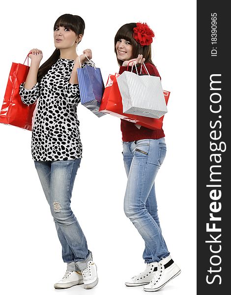 Two friends shopping with gift bags in hand. Two friends shopping with gift bags in hand