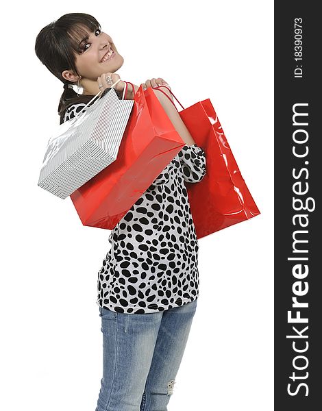 Young woman shopping with gift bags in hand. Young woman shopping with gift bags in hand