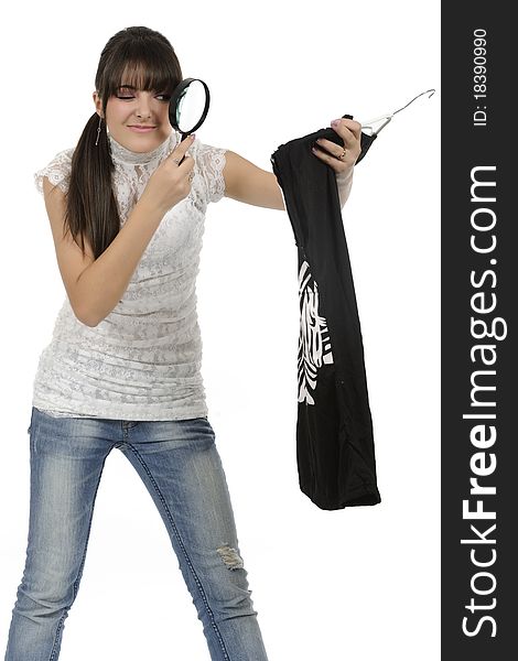 Young woman is holding a hanger with a T-shirt. Young woman is holding a hanger with a T-shirt