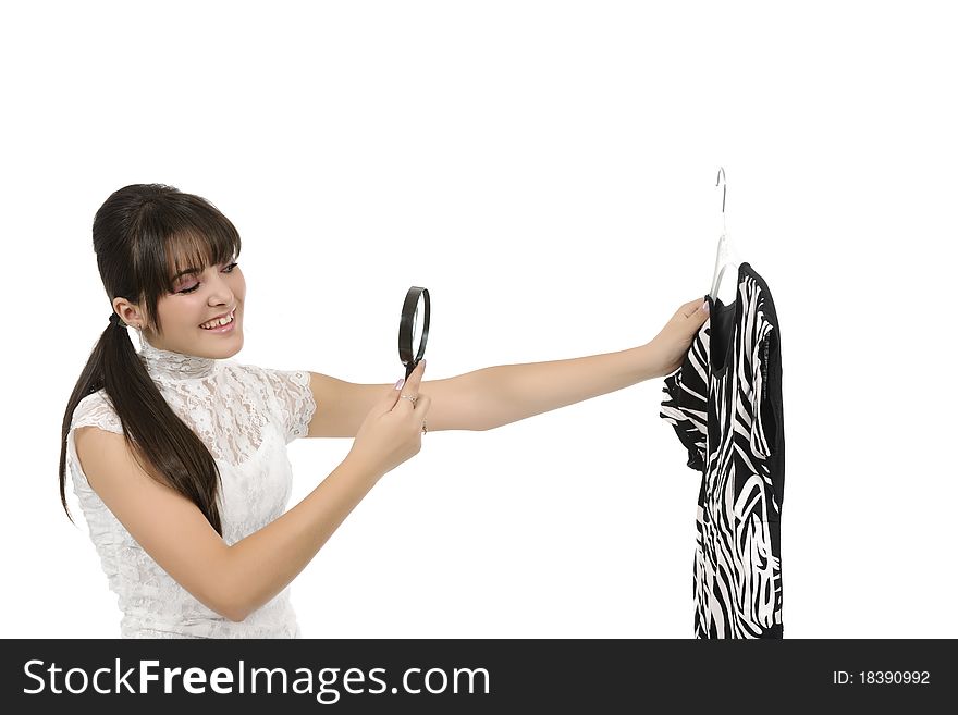 Young woman is holding a hanger with a T-shirt. Young woman is holding a hanger with a T-shirt