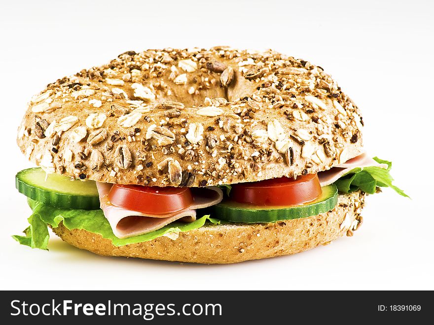 Freshly made sandwich with ham and vegetables over white background