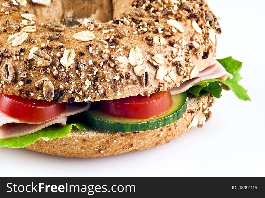 Freshly made sandwich with ham and vegetables over white background