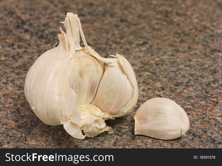 Garlic bulb and cloves on kitchen worktop. Garlic bulb and cloves on kitchen worktop