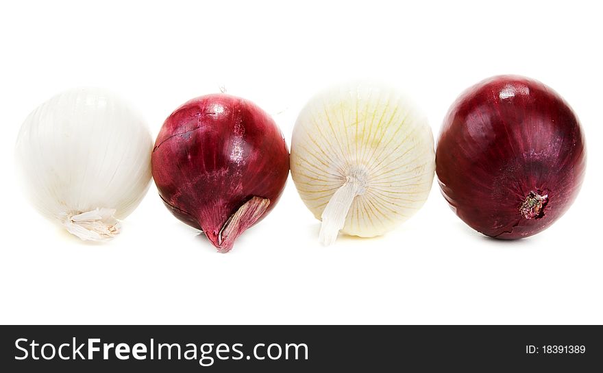 Light and blue onion lies in row on white background