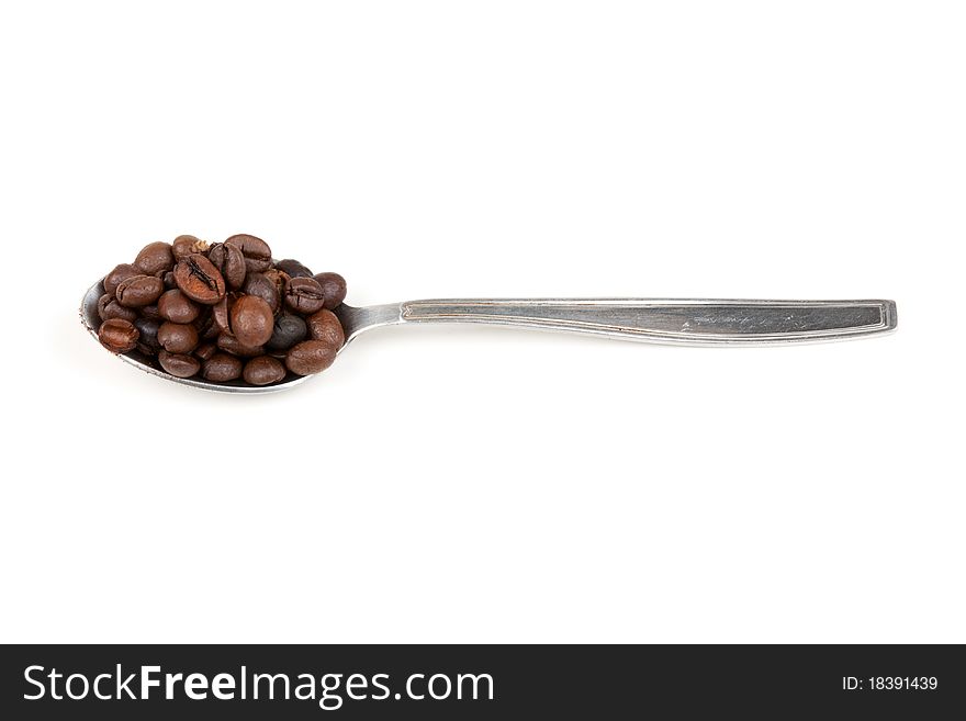 Spoon with coffee beans isolated on white background