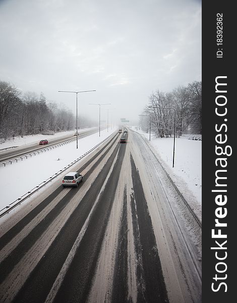 Traffic on a snowy highway in winter. Traffic on a snowy highway in winter