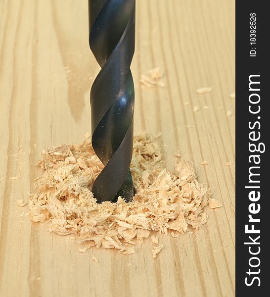 Closeup image of wood being drilled. Closeup image of wood being drilled.