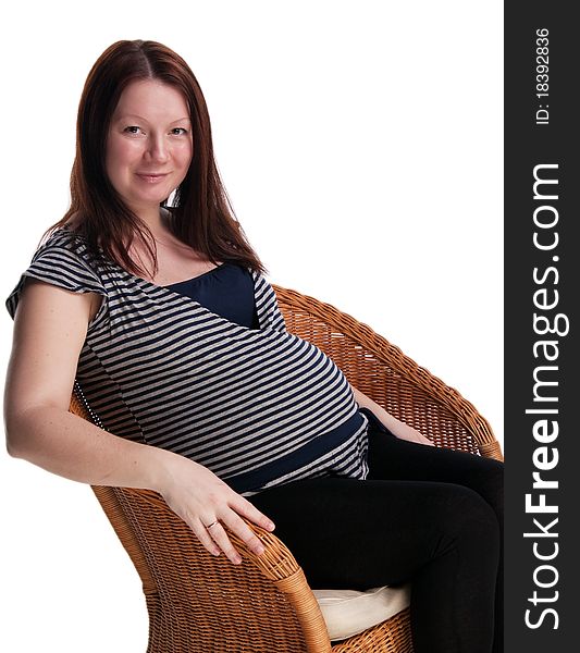 Portrait of beautiful pregnant woman sitting on the chair