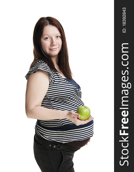 Beautiful pregnant woman holding green apple, isolated on white