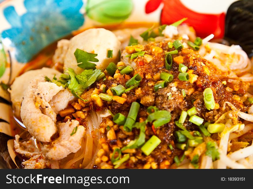 Thai noodle soup in a bowl on a white background taste spicy noodle soup.