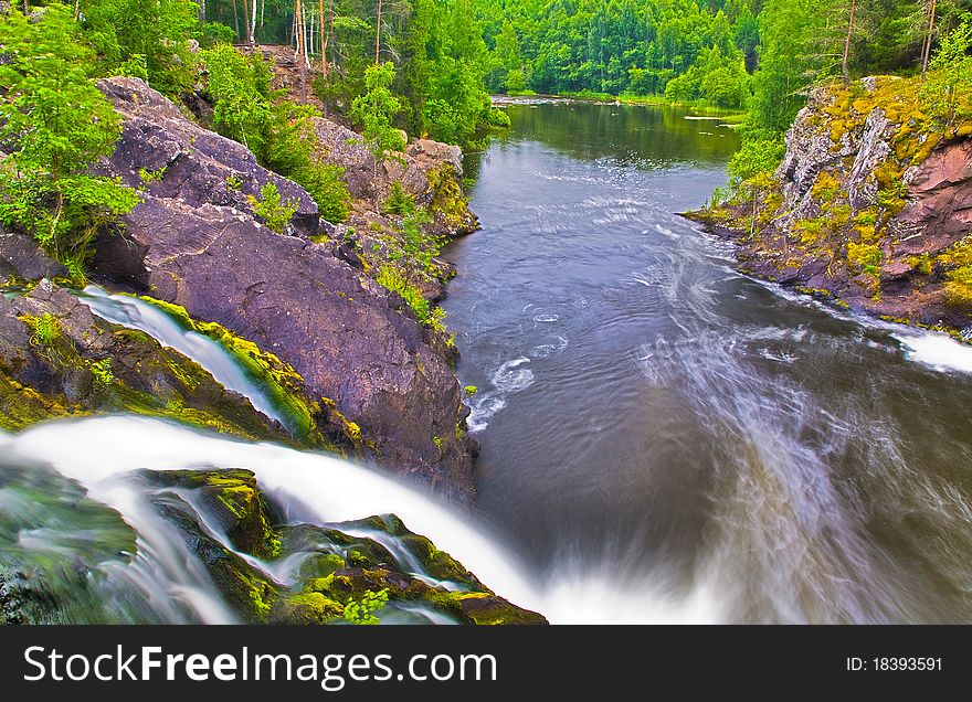 Waterfall and green forest near lake. Waterfall and green forest near lake