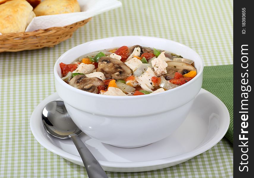 Chicken vegetable soup with mushrooms in a bowl