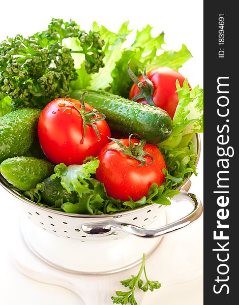 Tomatoes,cucumbers and Lettuce leaves in a colander. Tomatoes,cucumbers and Lettuce leaves in a colander