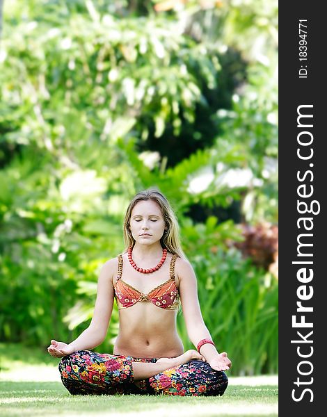 Young beautiful woman meditating on natural background. Young beautiful woman meditating on natural background