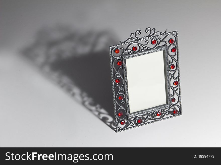 Empty photo frame with dramatic shadow on the table