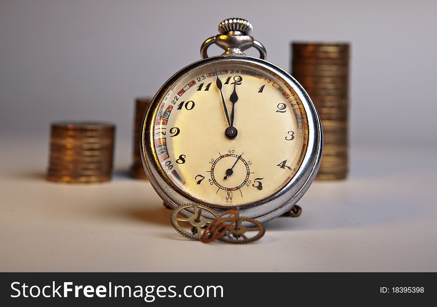 Pocket watch, coins, clockwork details. Pocket watch, coins, clockwork details