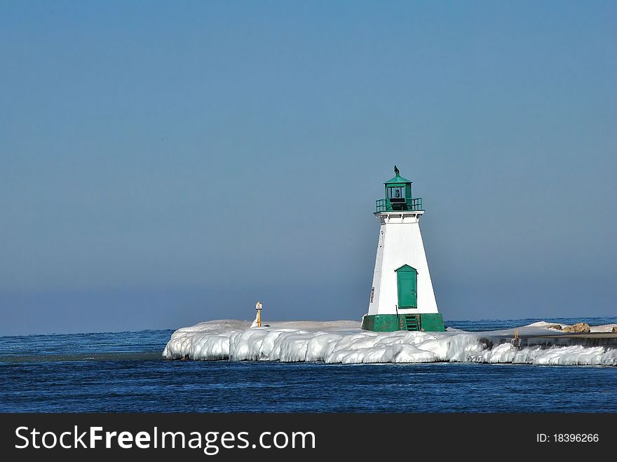 Lighthouse on an ice covered pier,lake ontario. Lighthouse on an ice covered pier,lake ontario