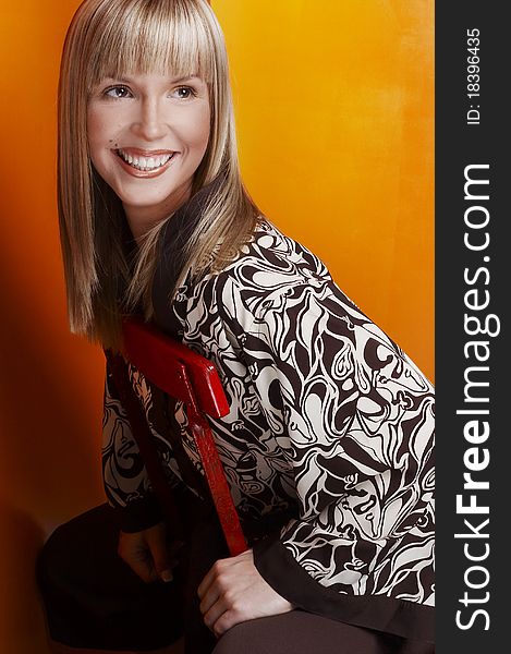 Smiling blonde woman sitting on the chair