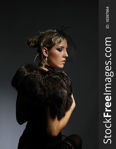 Portrait of a beautiful woman in a fur mantle