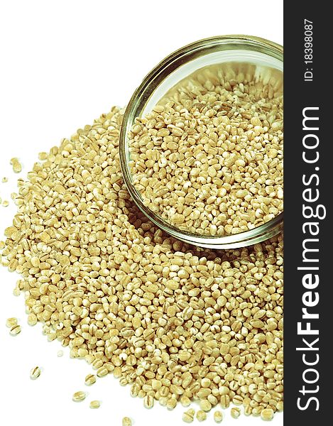 Loose pearl barley in a glass bowl, isolated on a white background. Loose pearl barley in a glass bowl, isolated on a white background