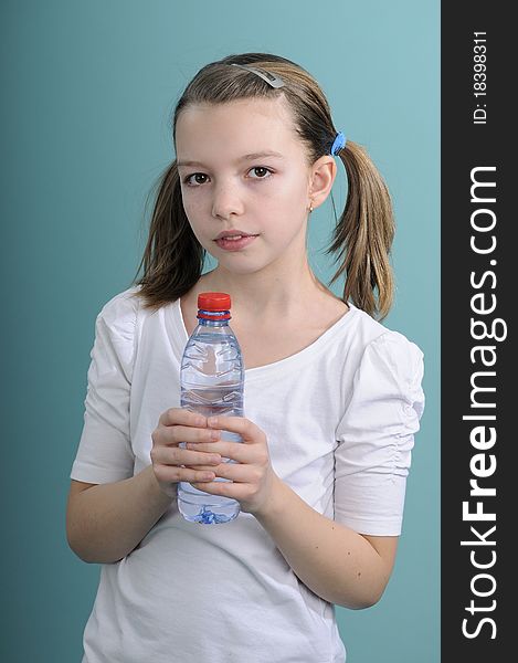 Active healhty schoolgirl relaxing with fresh water after exercises. Active healhty schoolgirl relaxing with fresh water after exercises