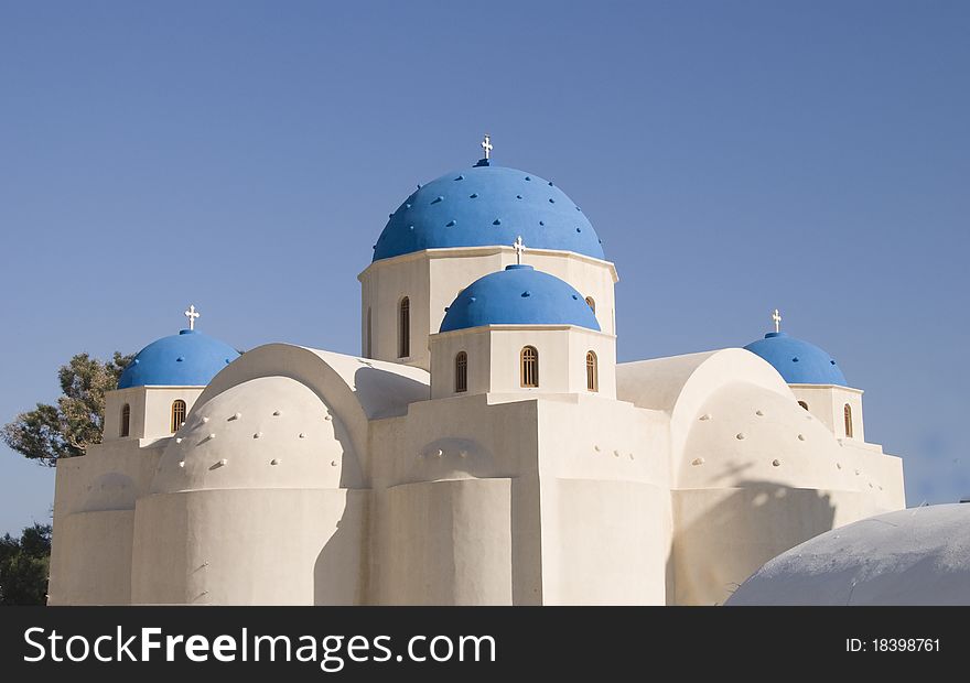 Greek Orthodox Church with traditional blue domes under a blue sky in may in Perissa,Santorini,Greece