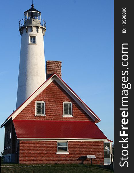 Tawas Point Lighthouse under bright blue sky. Tawas Point Lighthouse under bright blue sky
