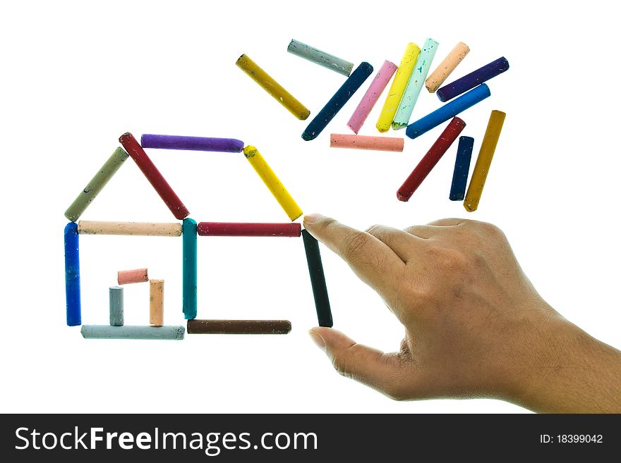 Oil pastel sticks as a house with a hand. Oil pastel sticks as a house with a hand