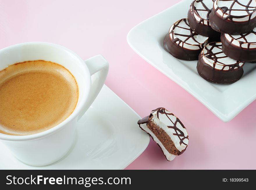 Coffee and chocolates on a pink background. Coffee and chocolates on a pink background