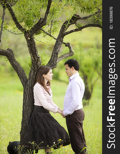 Young lovely couple staring each other in nature. Young lovely couple staring each other in nature.