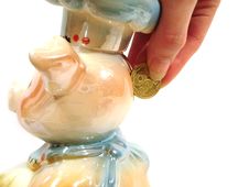 Hand Put Money In Piggy Ceramic Bank For Money Over White Backgr Stock Photo