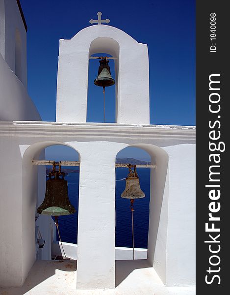 Bell tower with three bells on the greek island of Santorini. Bell tower with three bells on the greek island of Santorini