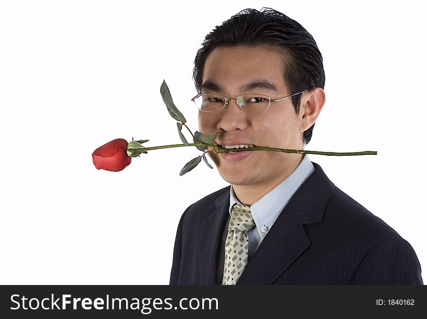 Asian young guy holding rose in mouth.