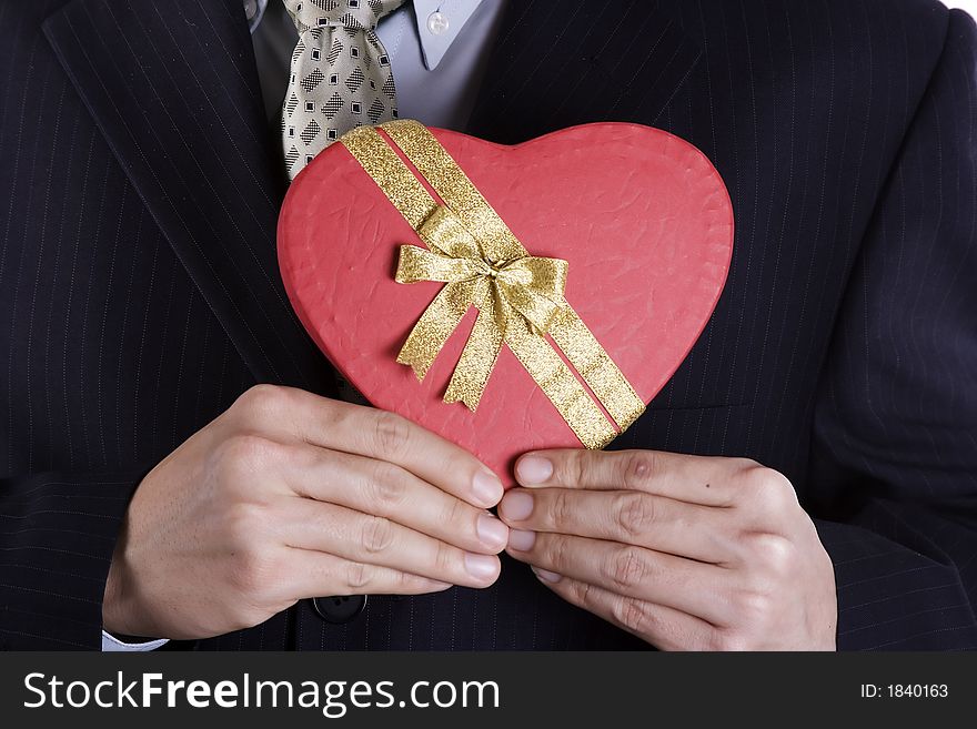 Both hand holding a heart shape gift box. Both hand holding a heart shape gift box.