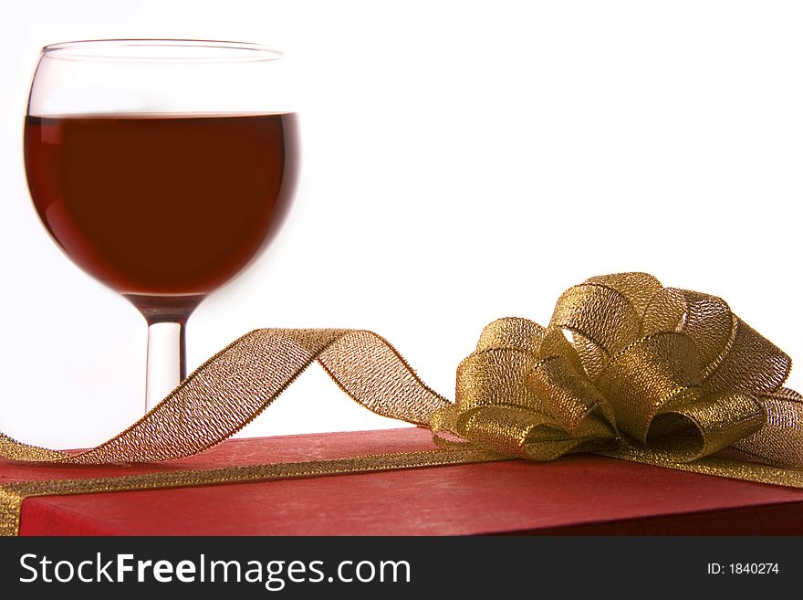 Red wine and red gift box with golden ribbon. Red wine and red gift box with golden ribbon.