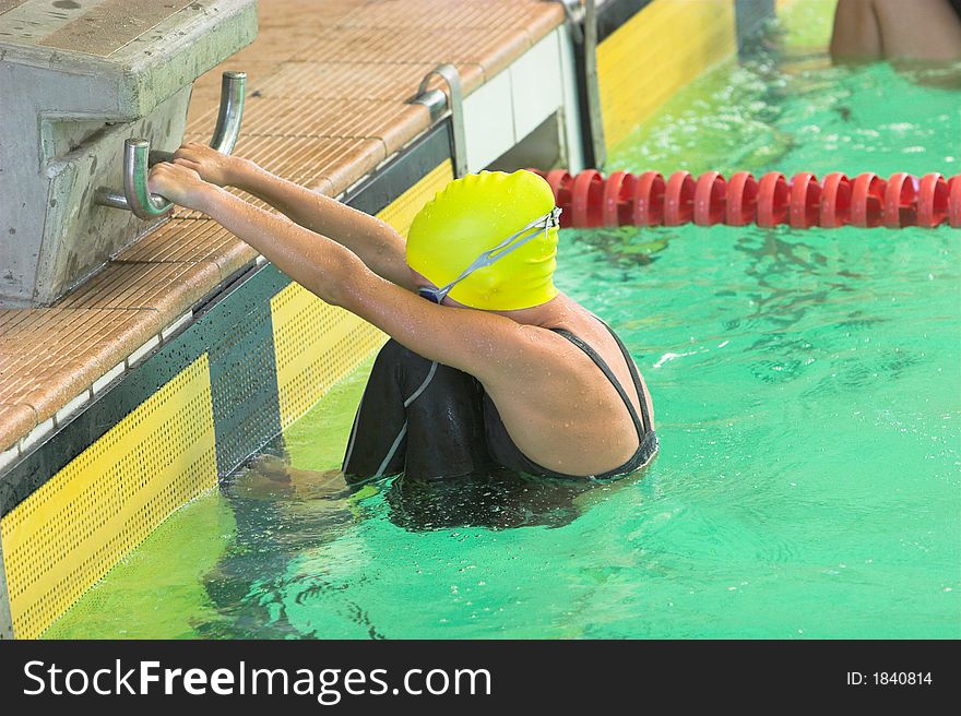 Girl on the starting blocks for backstroke swim. Girl on the starting blocks for backstroke swim